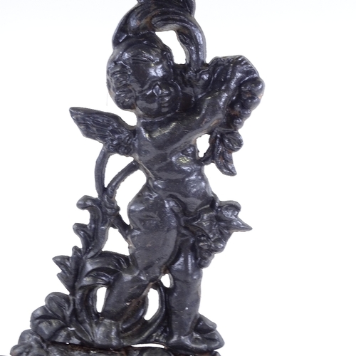 100 - A cast-iron stick stand with cherub support