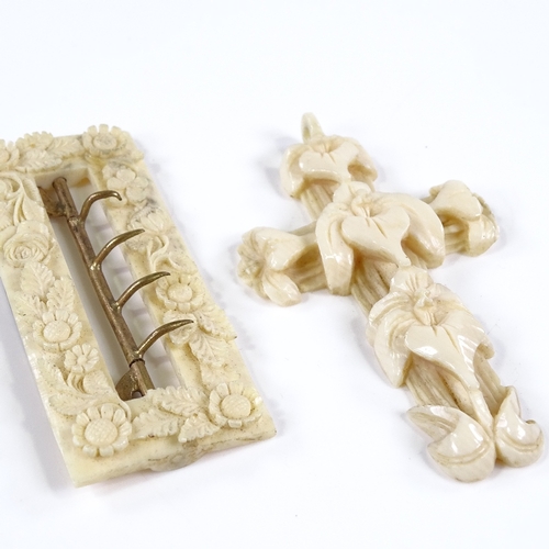 106 - A 19th century relief-carved Dieppe ivory cross pendant, length 7.5cm, and a floral carved ivory buc... 