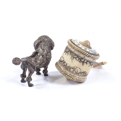 114 - An Edwardian cast-silver Poodle design pin cushion (no cushion), length 6.5cm, and an engraved bone-... 