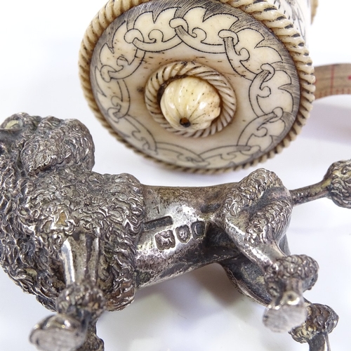 114 - An Edwardian cast-silver Poodle design pin cushion (no cushion), length 6.5cm, and an engraved bone-... 