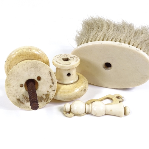 118 - A pair of Victorian ivory doorknobs and matching lock escutcheon, and an ivory handled brush