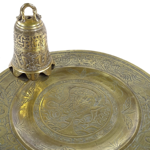 122 - A Chinese relief cast bronze dragon design bell, height 16cm, and an engraved bronze tray (2)