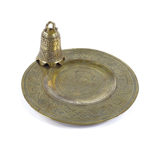 122 - A Chinese relief cast bronze dragon design bell, height 16cm, and an engraved bronze tray (2)