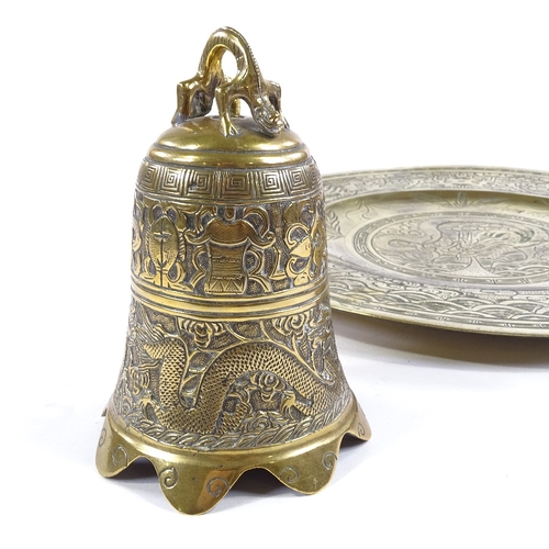 122 - A Chinese relief cast bronze dragon design bell, height 16cm, and an engraved bronze tray (2)