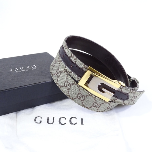 124 - A Gucci leather belt, new and boxed condition