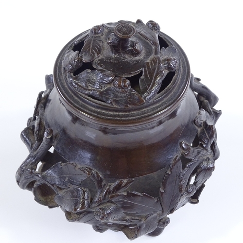 13 - A Chinese patinated bronze incense burner, with relief cast leaf moulded surround, and original cove... 