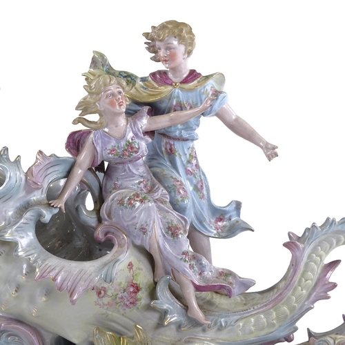 135 - A porcelain table centre bowl in the form of 2 children riding a seashell, length 36cm