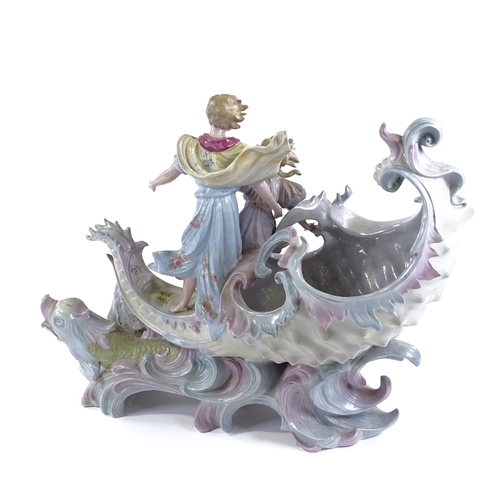 135 - A porcelain table centre bowl in the form of 2 children riding a seashell, length 36cm