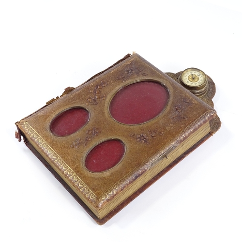 25 - A Victorian leather-bound photograph album, with brass-mounted clock set to the pediment, the front ... 