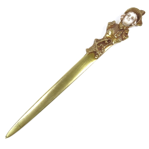 42 - A French gilt-bronze paper knife, circa 1900, the handle in the form of a lady's head with carved iv... 