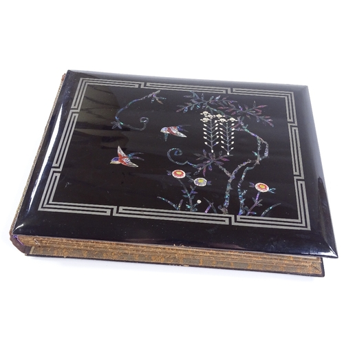 48 - A Japanese lacquer postcard album, circa 1900, with inlaid mother-of-pearl decoration, containing tr... 