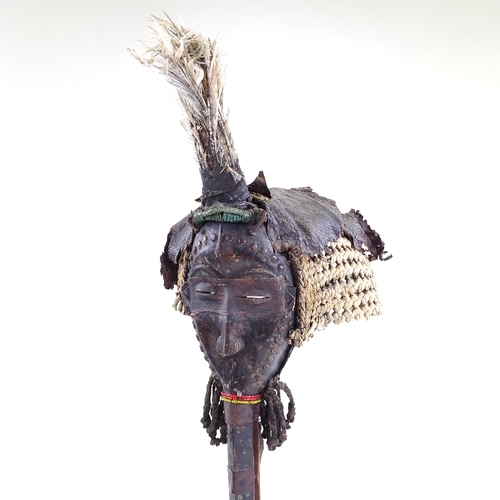 78 - An African Dan Tribal carved wood bird mask, with raffia, beadwork, and bird feather mounts, overall... 