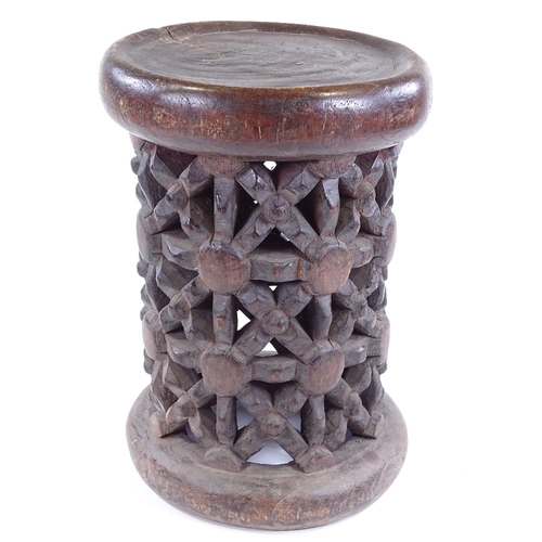 80 - A Cameroon Tribal carved and pierced wood spider design stool, height 37cm, diameter 26cm