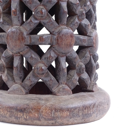 80 - A Cameroon Tribal carved and pierced wood spider design stool, height 37cm, diameter 26cm