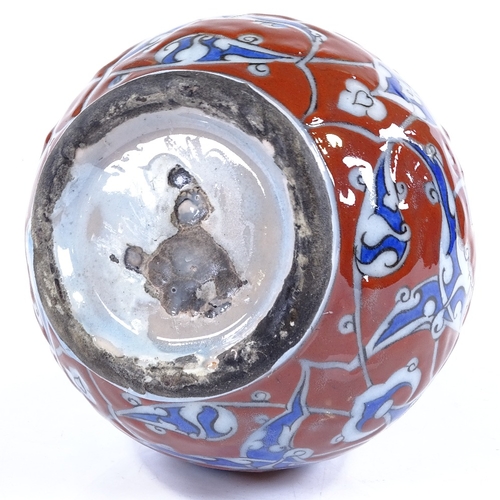 84 - A Turkish red and blue glaze narrow-necked bottle with painted enamel decoration, height 19cm