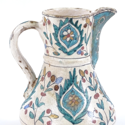 86 - A Turkish pottery coffee pot with hand painted decoration, height 16cm