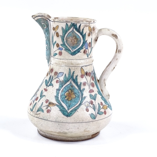 86 - A Turkish pottery coffee pot with hand painted decoration, height 16cm