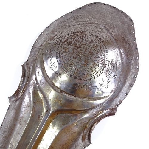 87 - An Islamic steel horse armour head piece, with engraved decoration and text, length 57cm