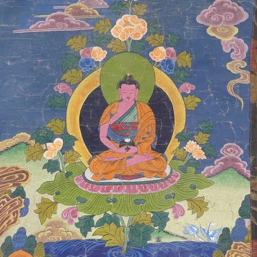 94 - A Chinese hand painted thangka depicting a seated Buddha, in floral textile border, 68cm x 50cm