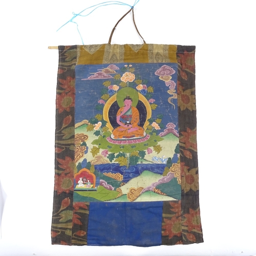 94 - A Chinese hand painted thangka depicting a seated Buddha, in floral textile border, 68cm x 50cm