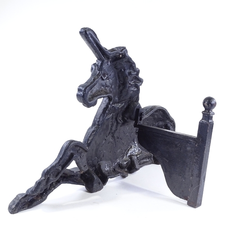 99 - A Victorian cast-iron unicorn design fire ornament, length 57cm