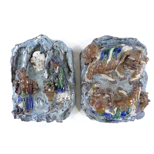 155 - A pair of 19th century Shiwan relief-moulded stoneware wall pockets, decorated with figures and Dogs... 