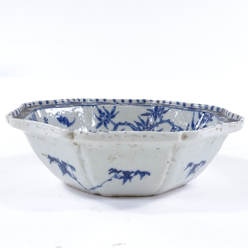 163 - A Chinese blue and white porcelain octagonal bowl with hand painted figures in gardens, 25cm across