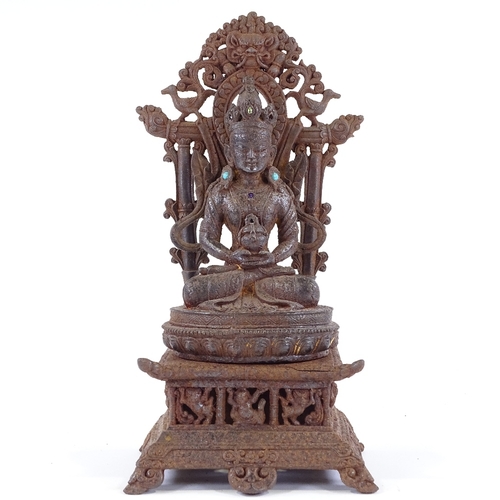 171 - A Chinese cast-iron seated Buddha and shrine with inset turquoise stones, height 35cm