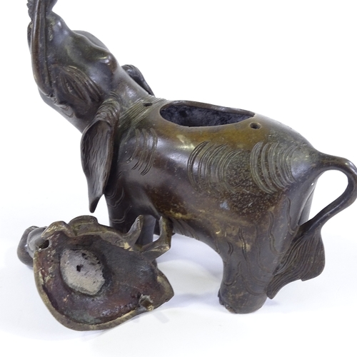 199 - A Chinese patinated bronze incense burner, in the form of a figure seated on an elephant, height 20c... 