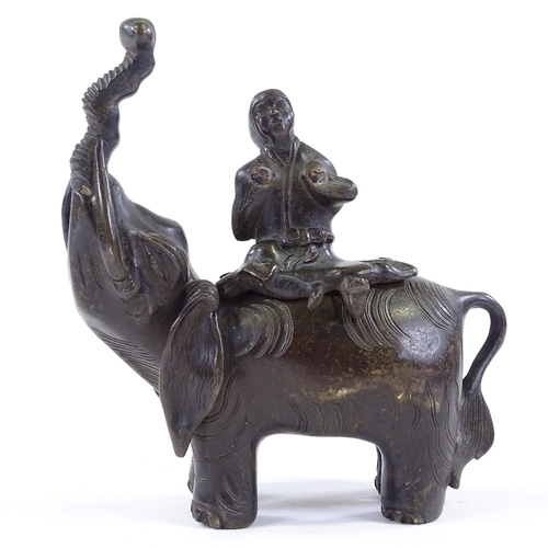 199 - A Chinese patinated bronze incense burner, in the form of a figure seated on an elephant, height 20c... 