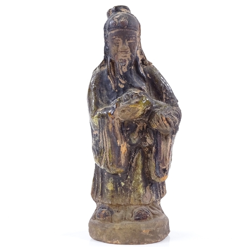 209 - A Chinese terracotta standing figure with traces of green glaze, height 12cm