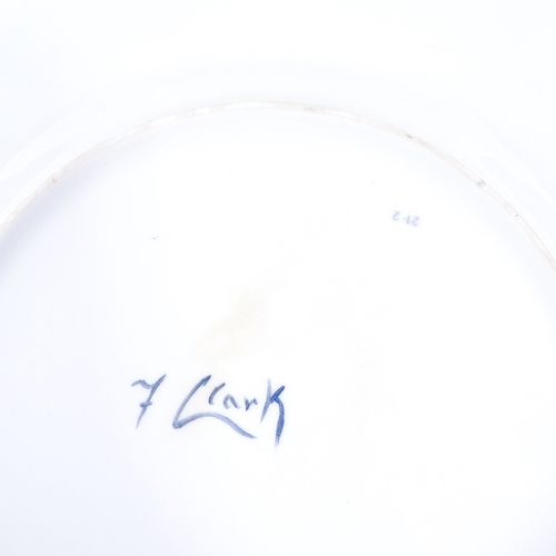 211 - A plate with hand painted scene depicting sheep in a landscape, signed Francis Clark, diameter 27cm