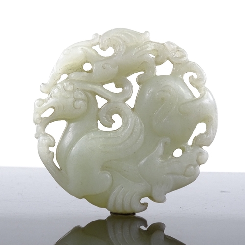 247 - A Chinese relief carved and pierced jade pendant, 5cm across