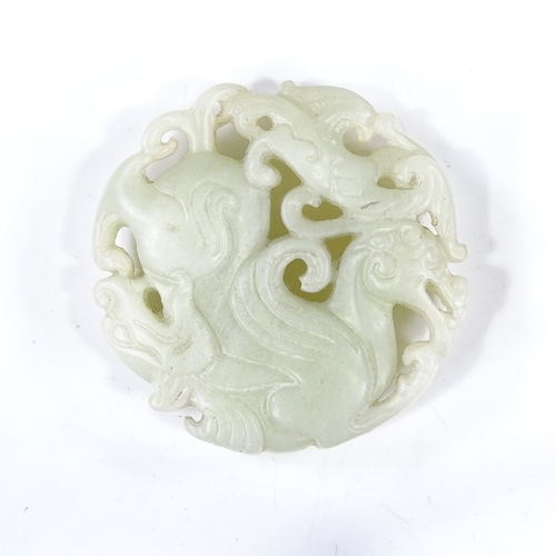 247 - A Chinese relief carved and pierced jade pendant, 5cm across