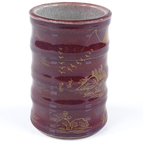 284 - A Chinese red glaze porcelain brush pot with hand painted gilded landscape design, gold painted 4 ch... 