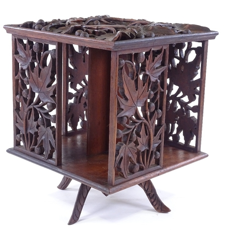 306 - A 19th century relief carved wood revolving book case, width 29cm, height 35cm