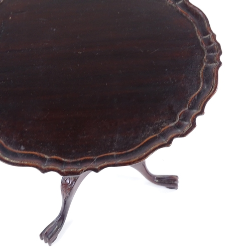 307 - A miniature mahogany tilt-top table on carved tripod base, 30cm across