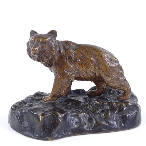 311 - A small patinated bronze bear on rocky base, indistinctly signed, length 11cm