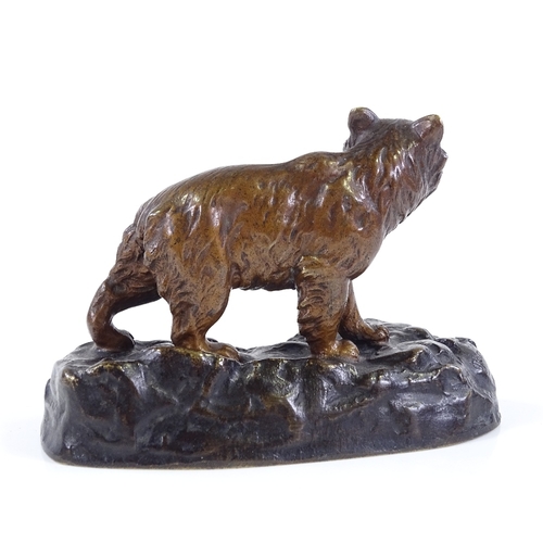 311 - A small patinated bronze bear on rocky base, indistinctly signed, length 11cm