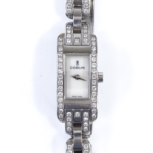 356 - CORUM - a lady's stainless steel Baguette quartz cocktail wristwatch, with diamond set bezel and str... 