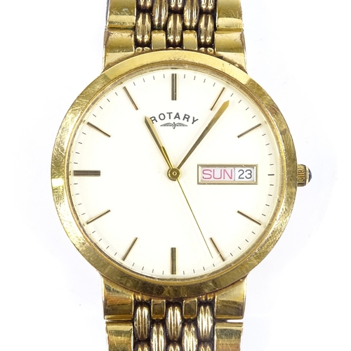 417 - ROTARY - a gold plated quartz wristwatch, cream dial with gilded baton hour markers and day date ape... 