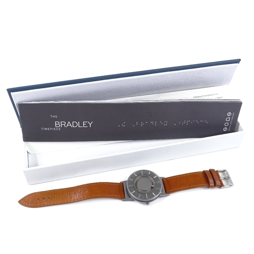 426 - THE BRADLEY TIMEPIECE - a titanium Eone quartz wristwatch, silvered dial with baton hour markers and... 