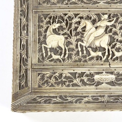 314 - An 18th/19th century ivory box, the relief carved and pierced lid depicting a stag hunting scene, wi... 