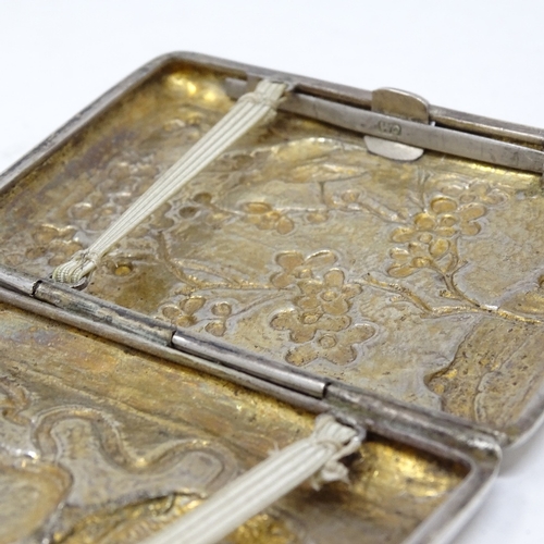 819 - A Chinese silver cigarette case, with relief embossed dragon and flower decoration, stamped on butto... 