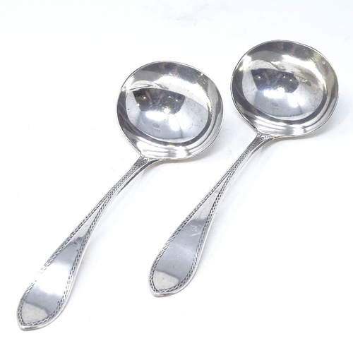 827 - A pair of Victorian silver ladles, with engraved bordered handles, by Walker & Hall, hallmarks Sheff... 