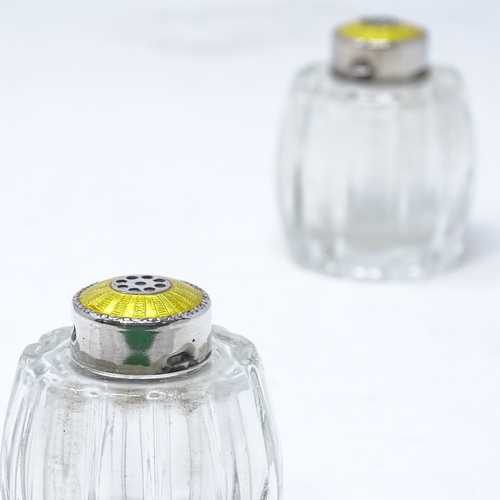 832 - A pair of Danish sterling silver and yellow enamel glass pepperettes, by Hugo Grun of Copenhagen, he... 