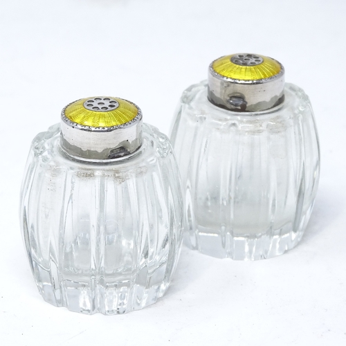 832 - A pair of Danish sterling silver and yellow enamel glass pepperettes, by Hugo Grun of Copenhagen, he... 