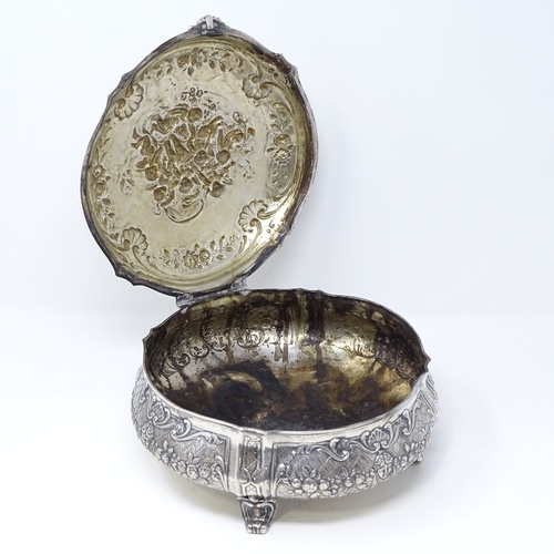 845 - A large German circular silver box, with hinged lid, on scrolled acanthus leaf feet, relief embossed... 