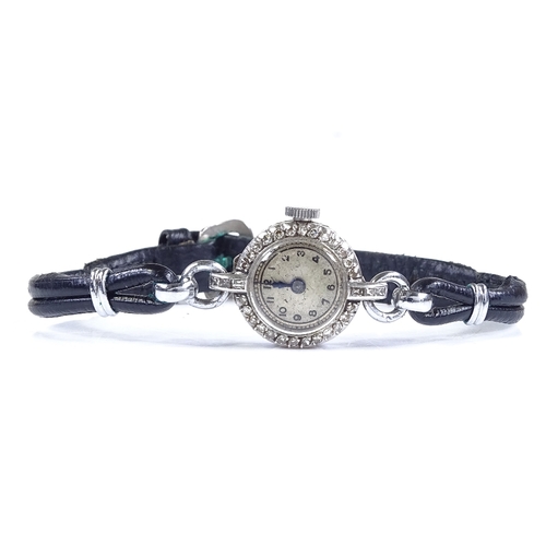 390 - A lady's platinum cocktail wristwatch, with diamond set bezel and leather strap, case width 16mm, no... 