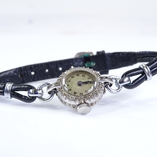 390 - A lady's platinum cocktail wristwatch, with diamond set bezel and leather strap, case width 16mm, no... 